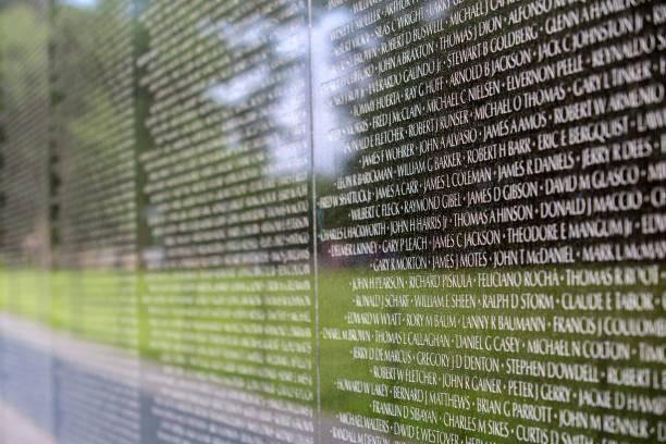 All angles network: A close up of the names of dead solidiers on the reflective black marble on the Vietnam Memorial on the Mall in Washington DC. Each name is in chronological order of their death.