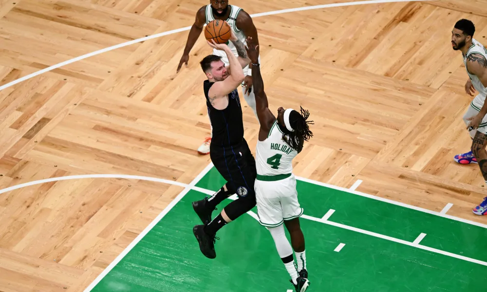 Jrue Holiday, now in a Boston Celtics jersey, playing suffocating defense against Luka Dončić during Game 5 of the 2024 NBA Finals. Holiday's relentless defense disrupted the Mavericks' game plan, shifting the momentum in Boston's favor. This critical play helped set the stage for the Celtics' eventual victory. Covered by Matt Goren for All Angles, this moment highlights Holiday's elite defensive intelligence and his impact on championship success.